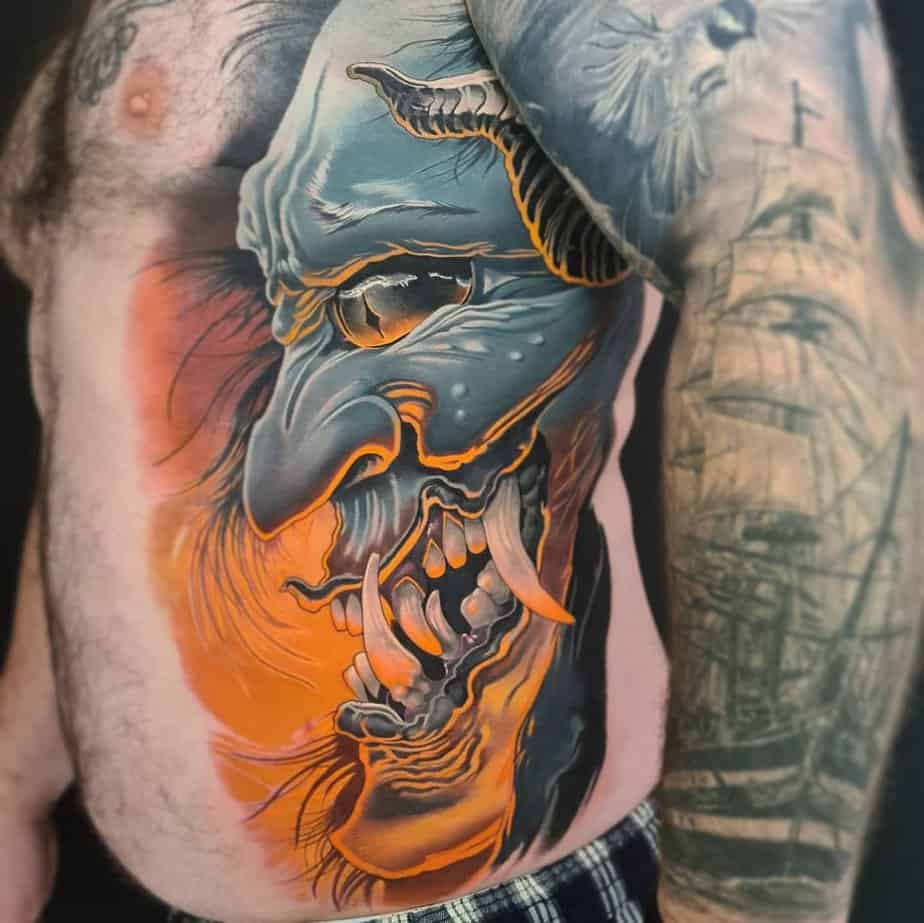 Fiery wrath Hannya tattoo lighting up the side of the body