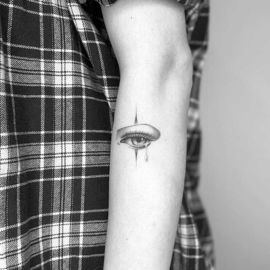Detailed teardrop eye tattoo with shading