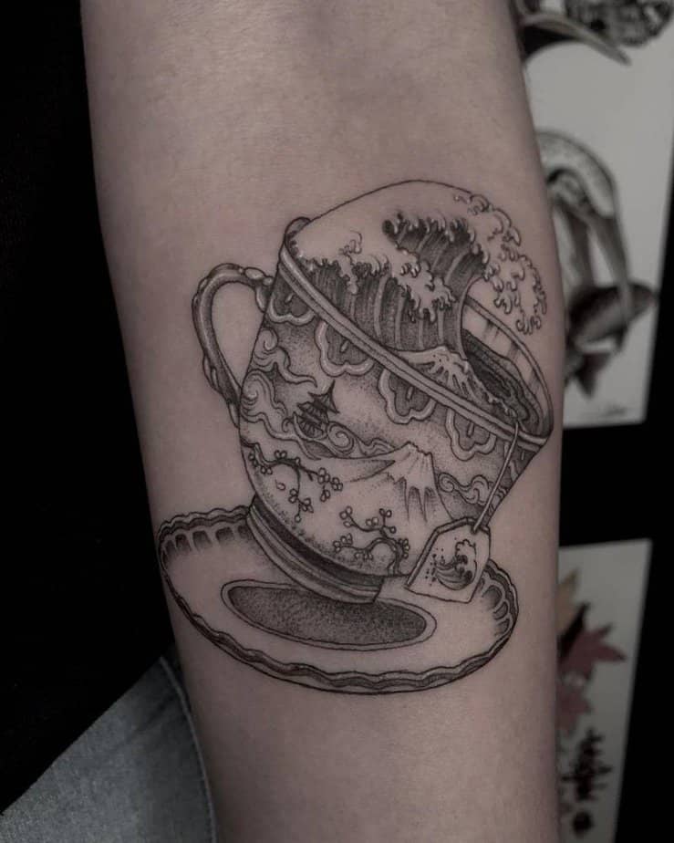 Black-and-gray teacup with Great Wave-inspired scene