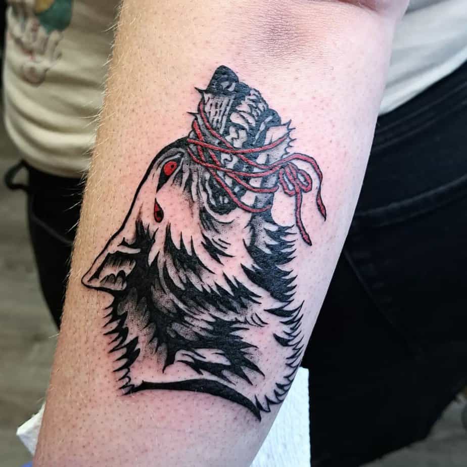 Red-thread wolf tattoo
