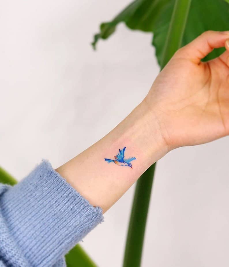 Tiny bluebird tattoo on the wrist