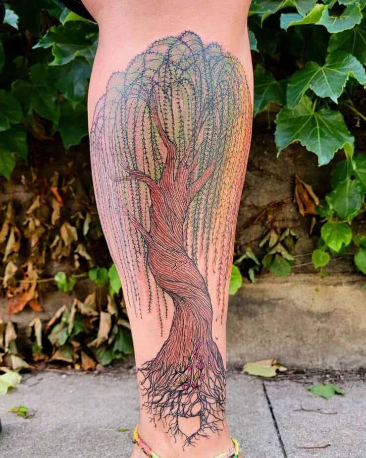 Weeping willow tattoo flowing down the leg