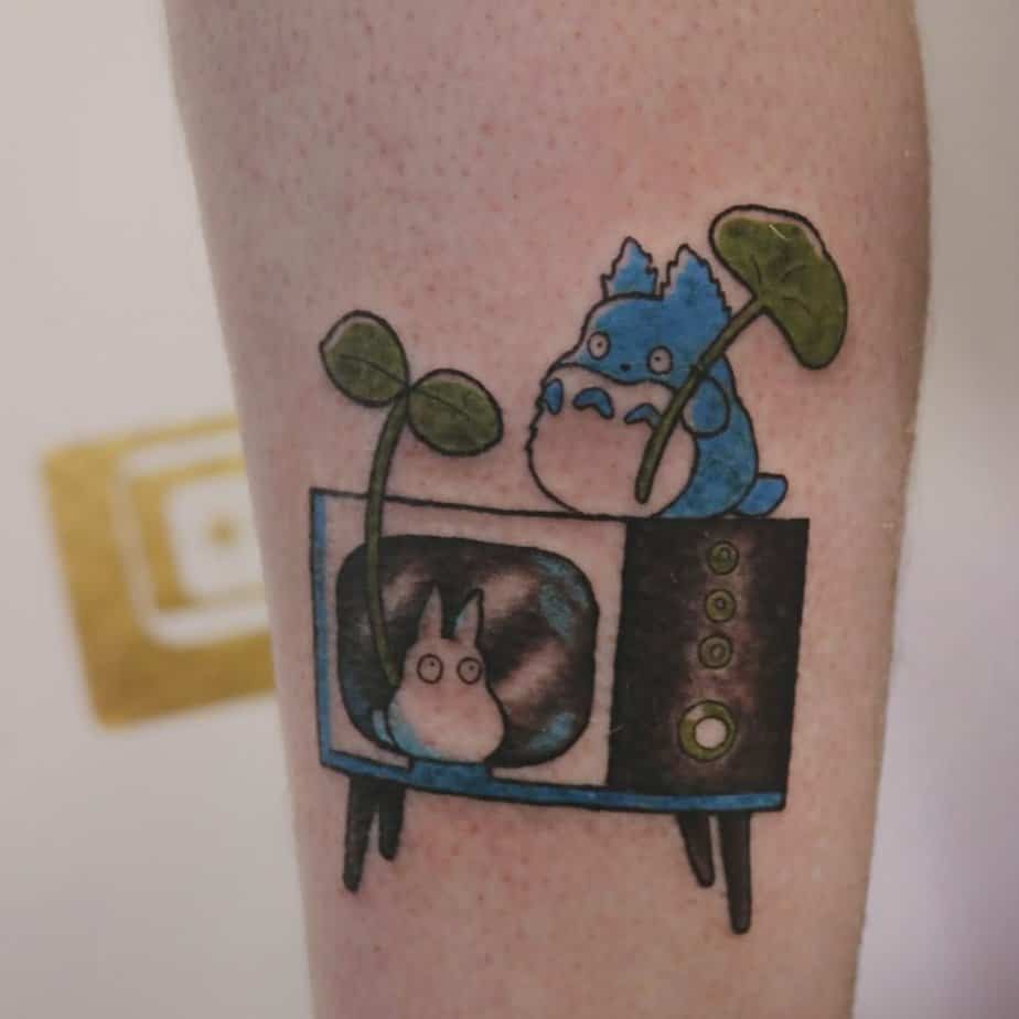 Totoro perched on a vintage TV with a tiny Totoro on screen