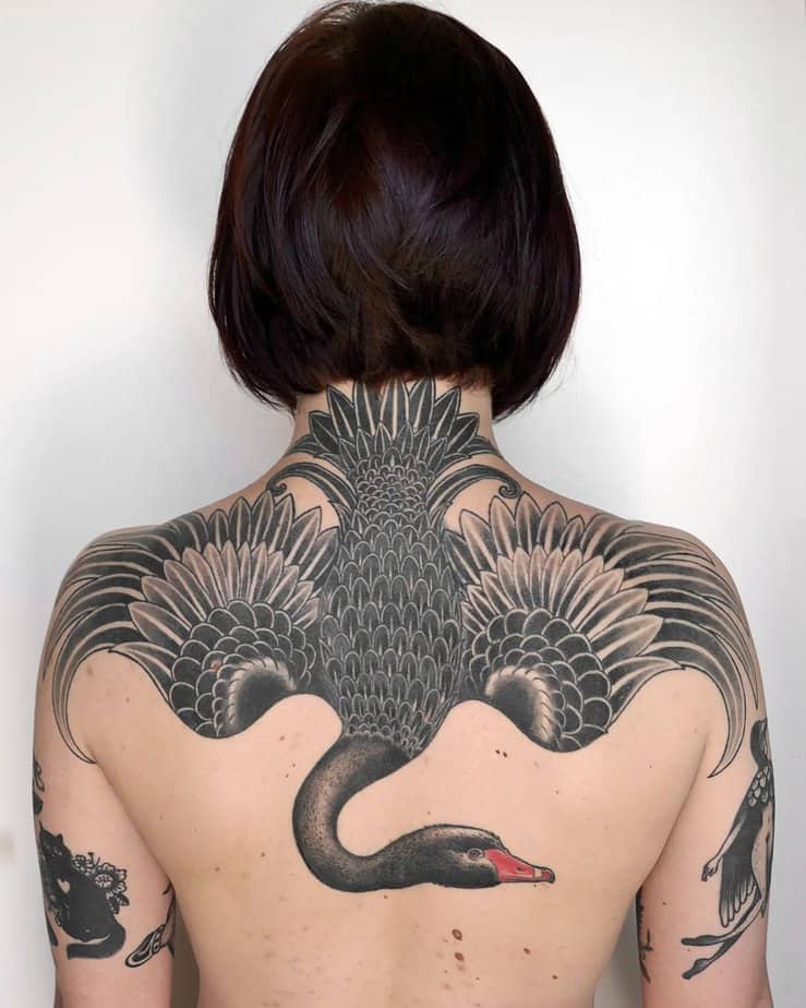 Black swan shoulder to back tattoo