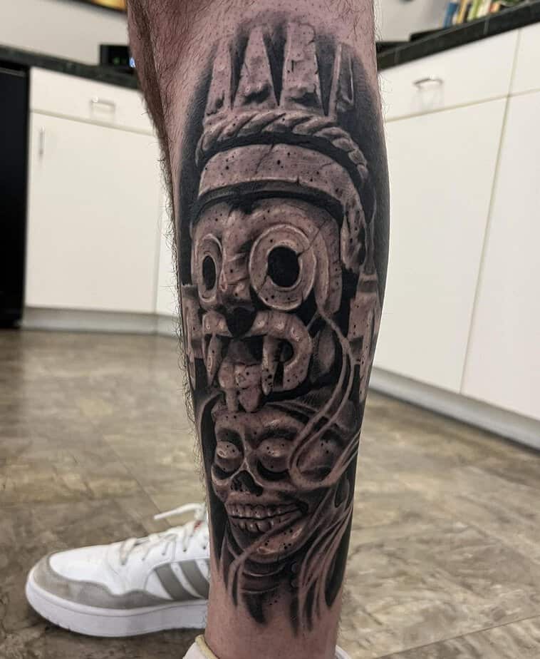 Striking Aztec skull leg tattoo