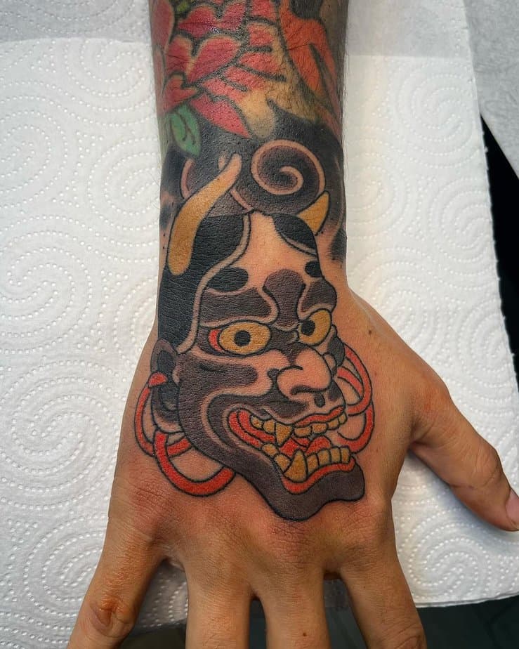 Vibrant Hannya tattoo on the hand