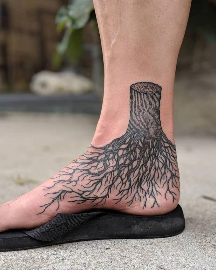 Tree stump tattoo on the foot with roots