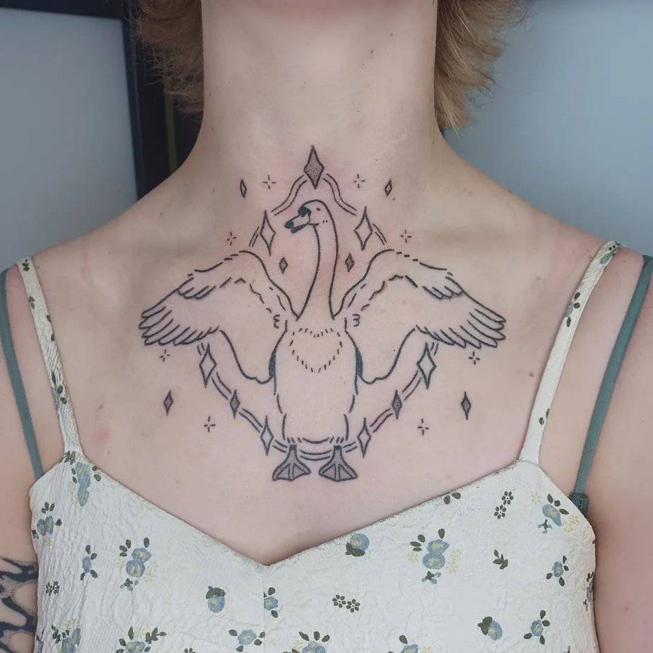 Sparkling swan chest tattoo surrounded by stars