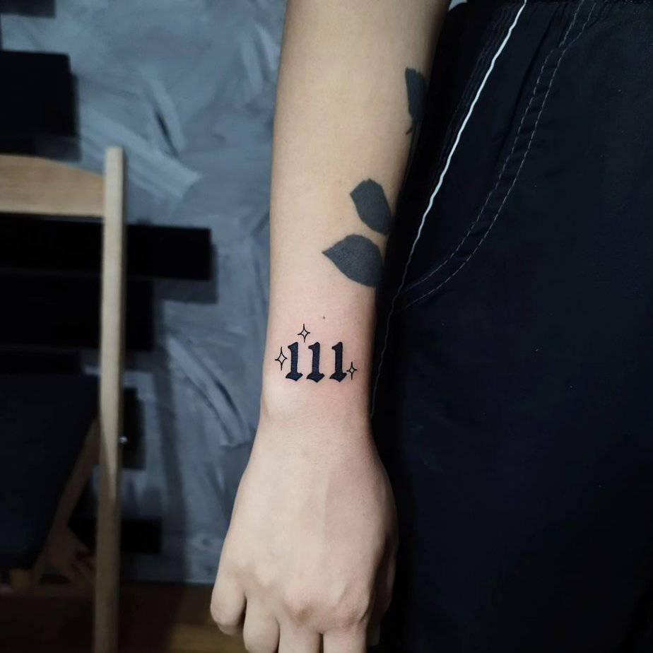 111 tattoo in bold black ink