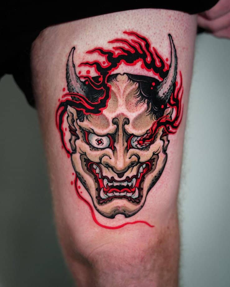 Thigh Hannya tattoo with flaming red accents