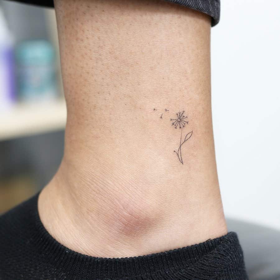 Dandelion micro tattoo on ankle