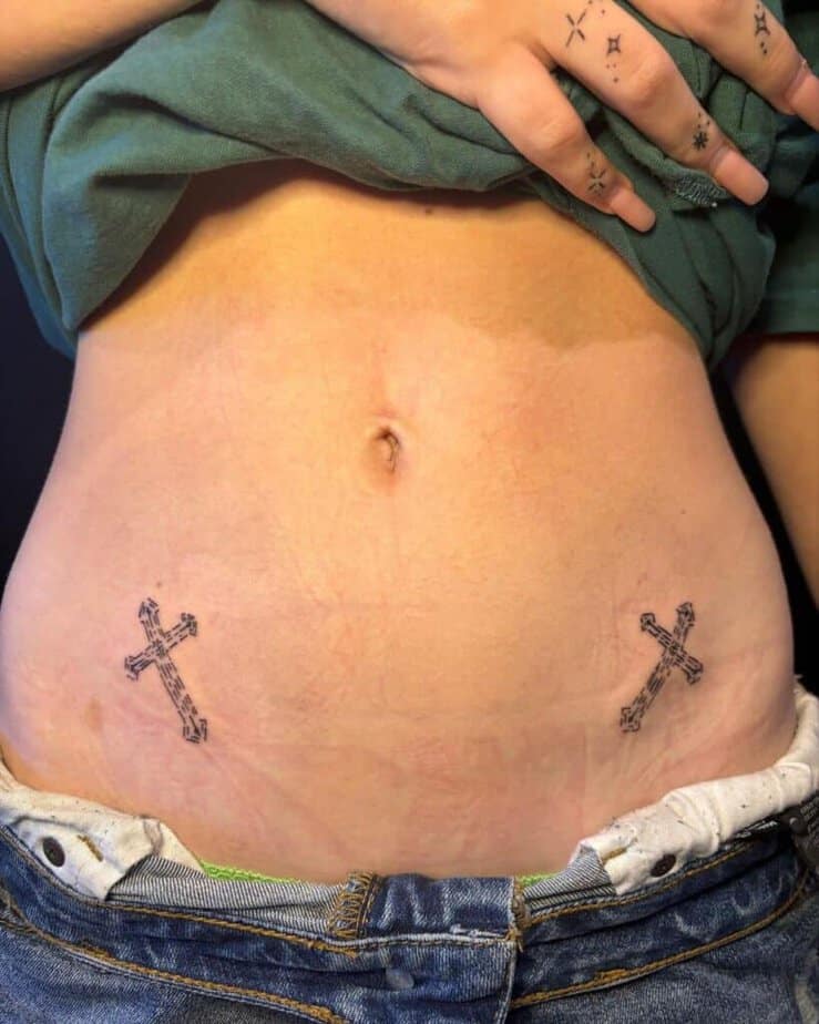 Simple crosses stomach tattoo
