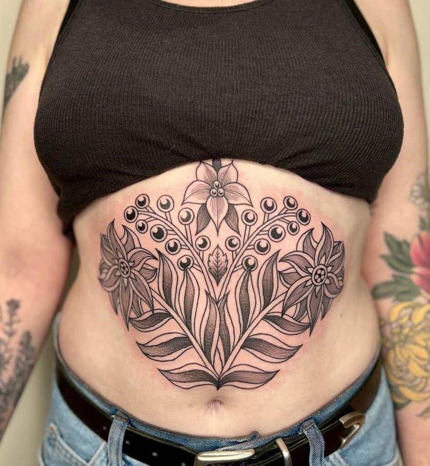 Naturalistic floral stomach tattoo