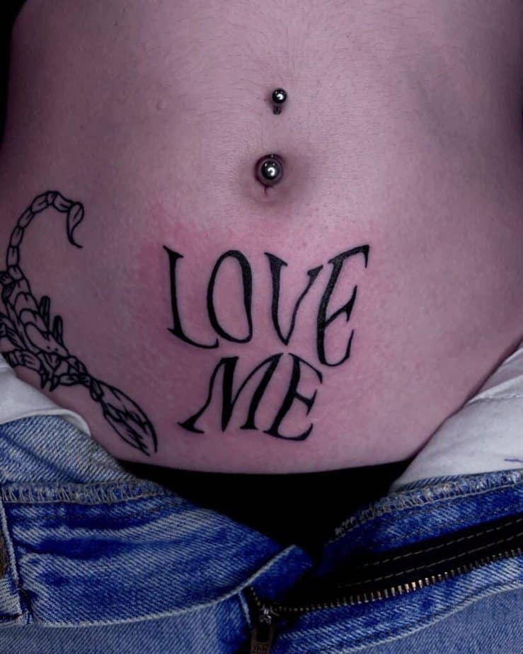 Distorted lettering stomach tattoo