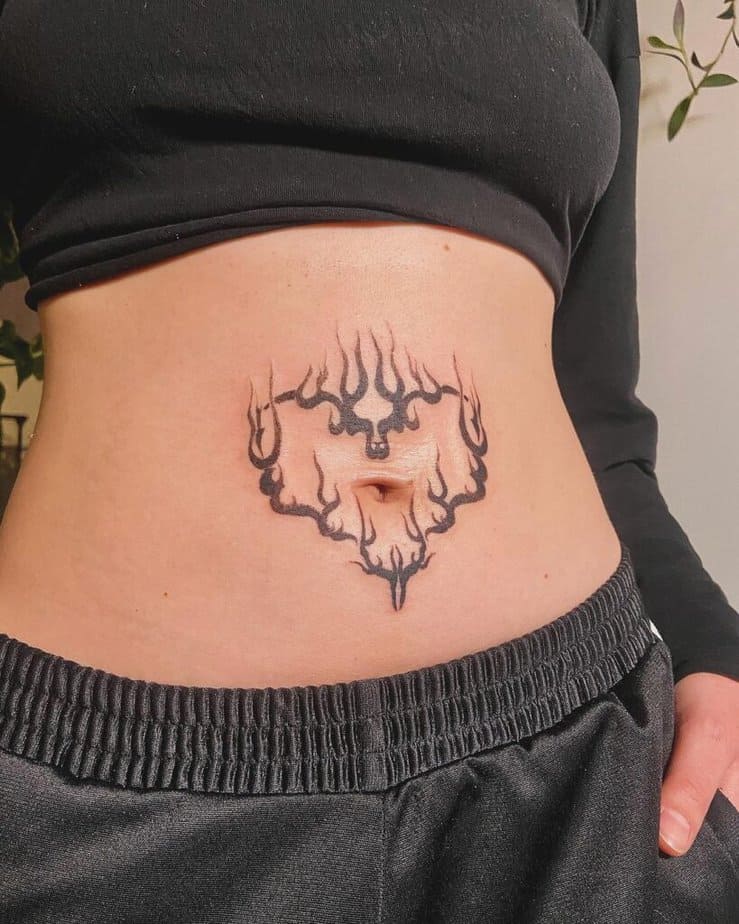 Flaming heart stomach tattoo
