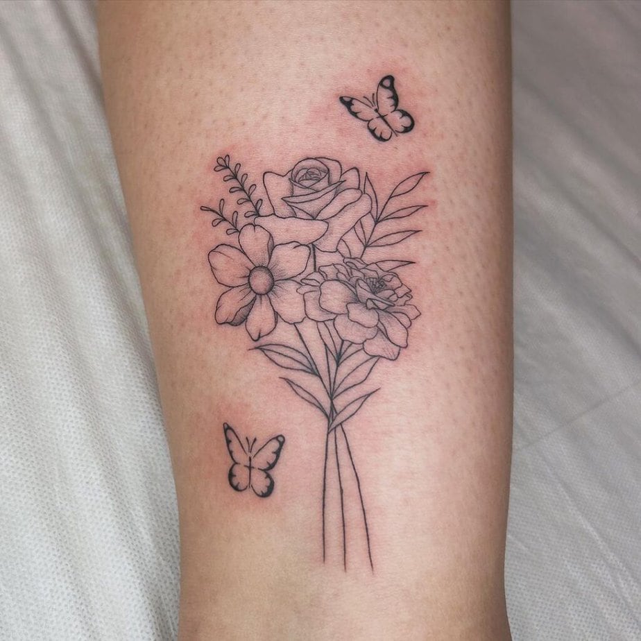 Fine-line floral bouquet tattoo