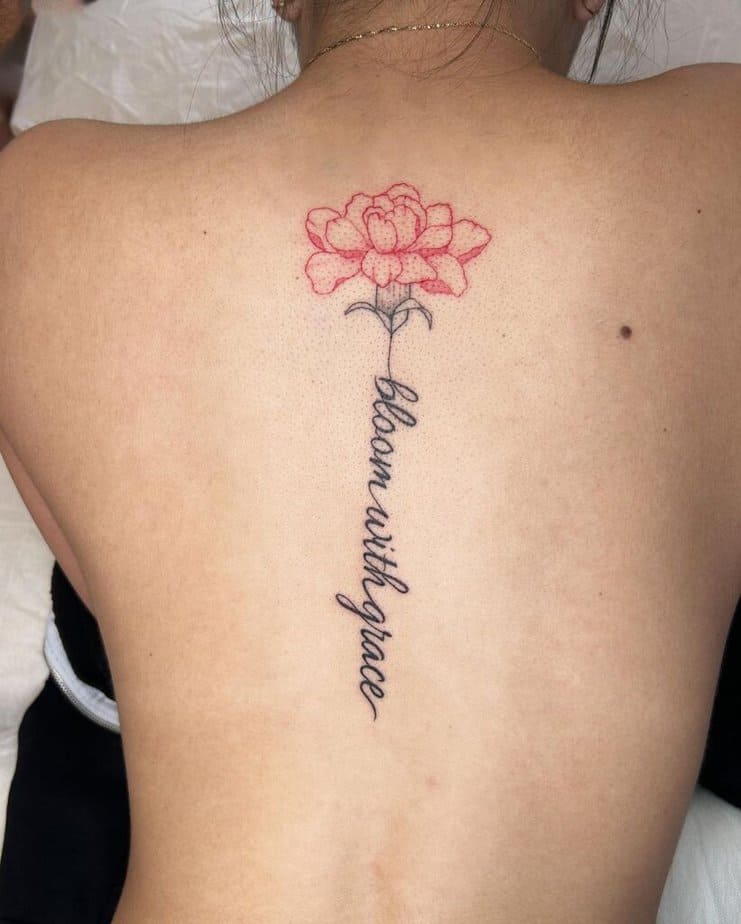 Fine-line back tattoo with red accents