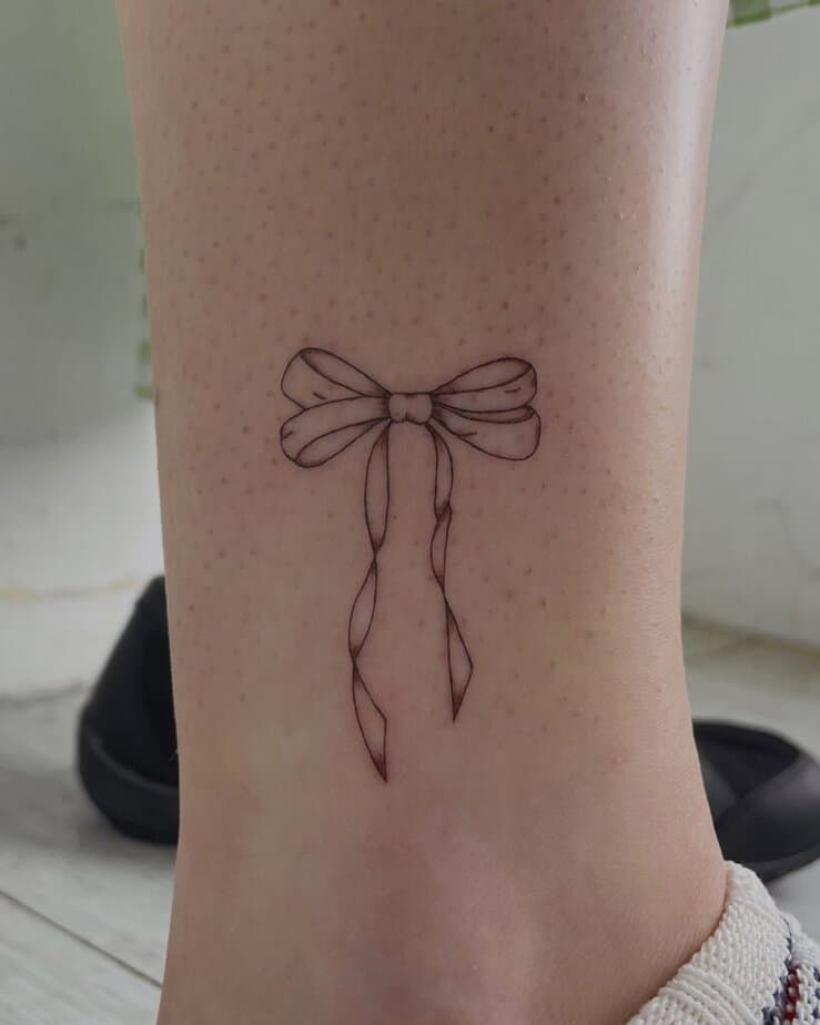 Fine-line bow tattoo
