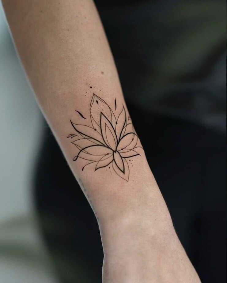Fine-line lotus tattoo