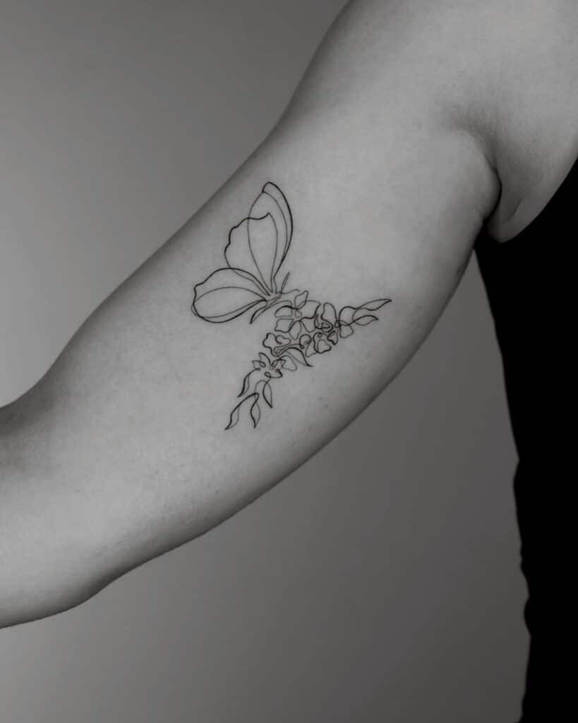 Fine-line butterfly tattoo