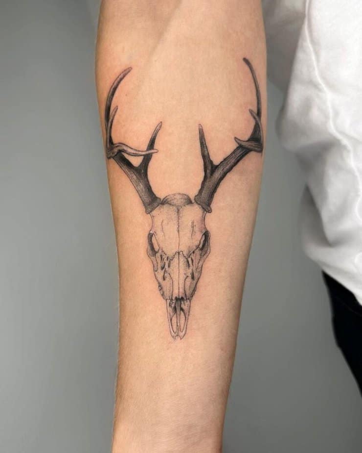 5. A deer skull tattoo on the forearm