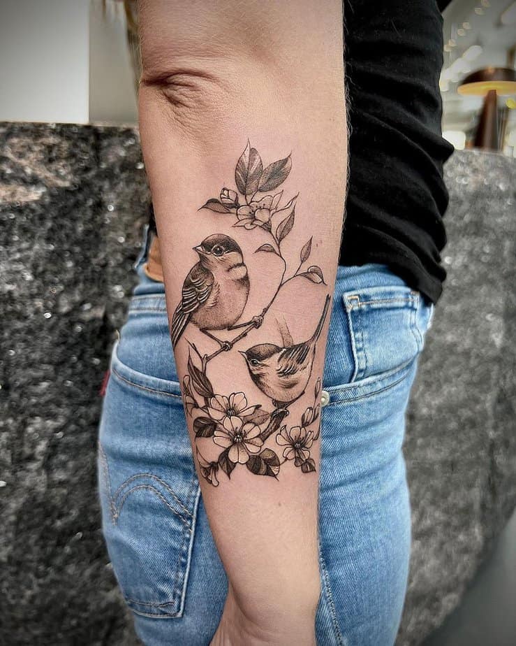 A cute cover-up tattoo with sparrows and flowers