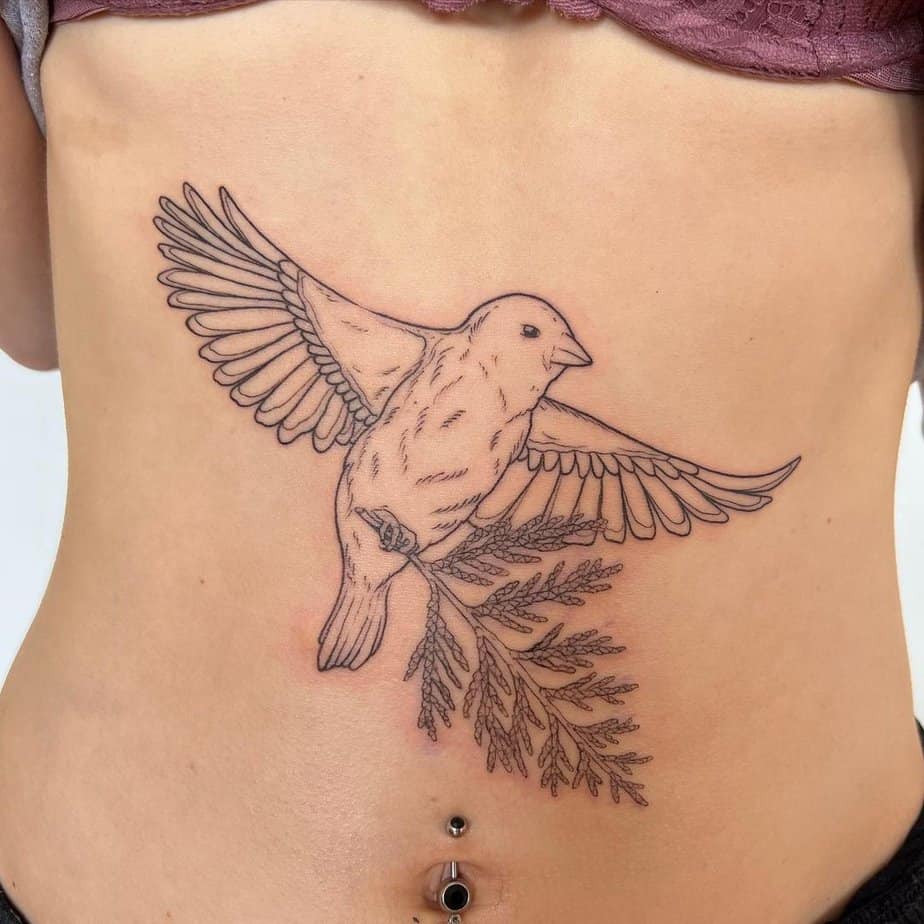 20. A sparrow tattoo across the abdomen