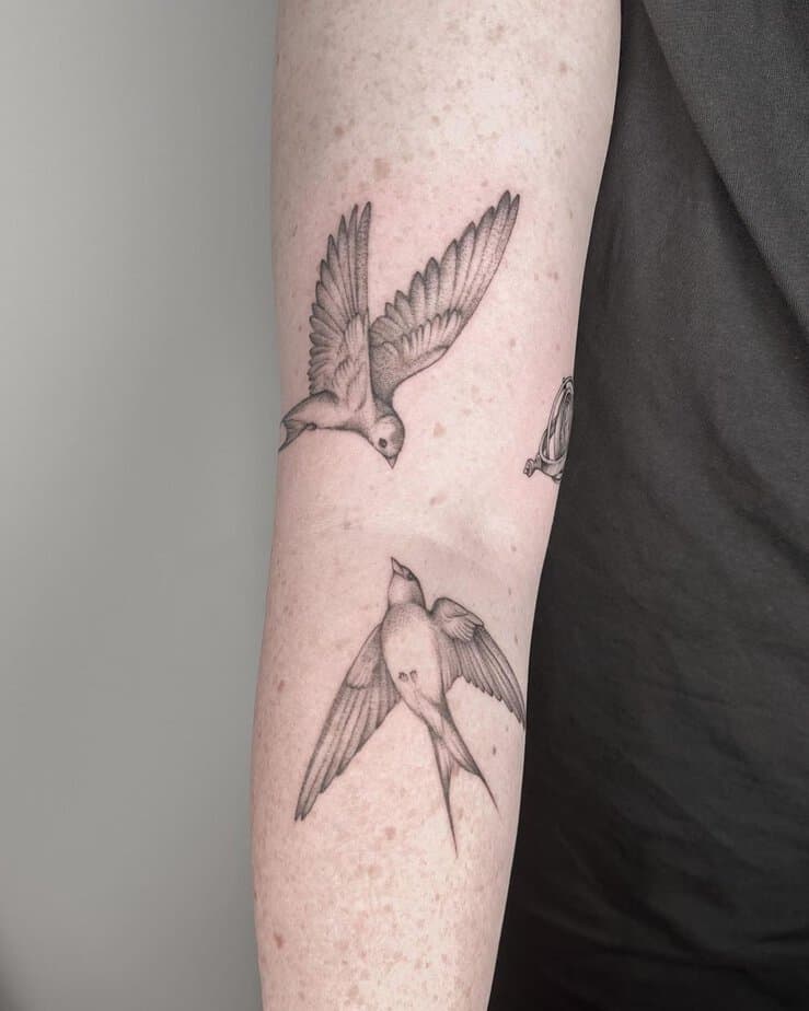 9. A tattoo of two softly shaded sparrows