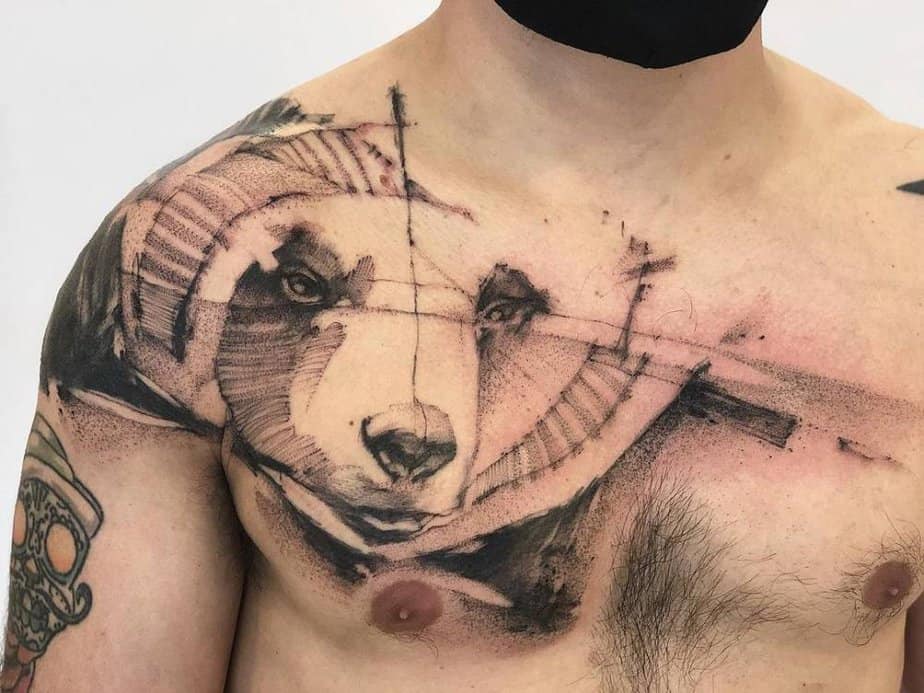 Abstract sketch-style bear tattoo on the chest