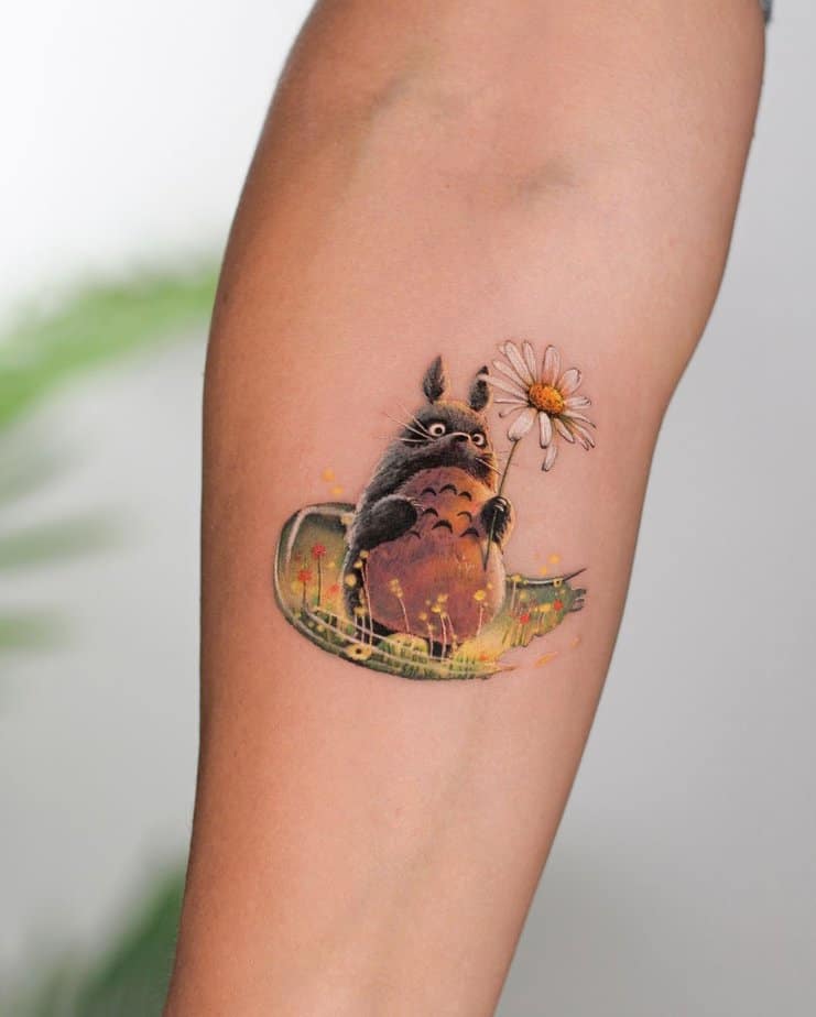 Totoro holding a daisy in a serene meadow