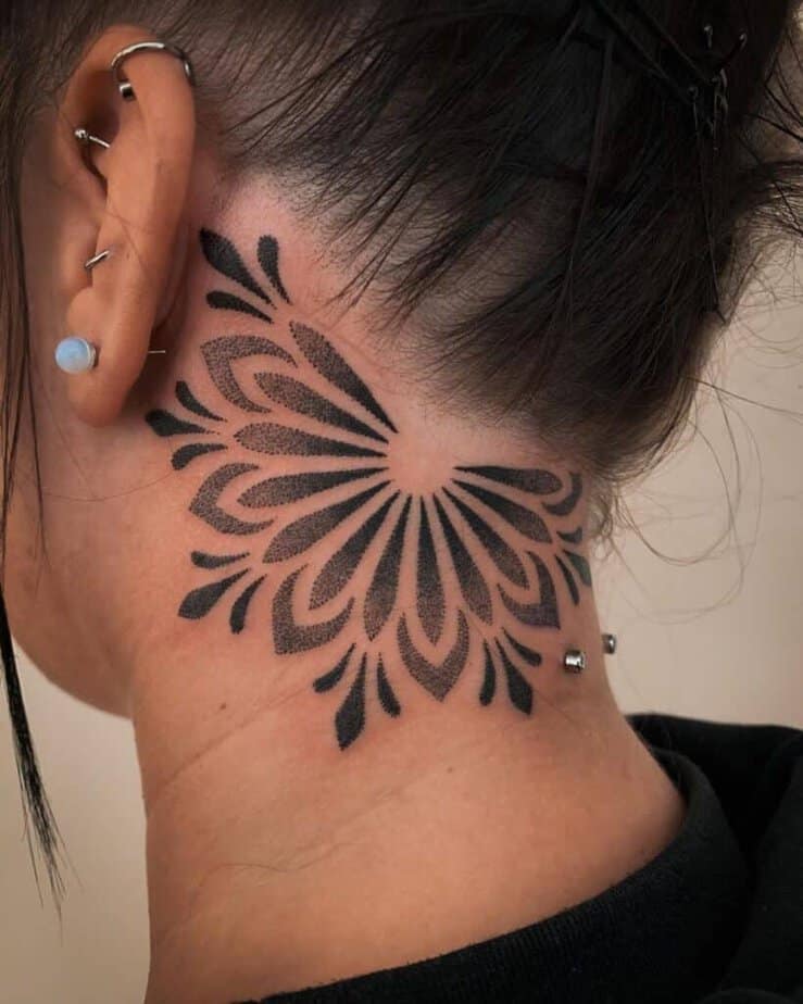 11. A dotwork behind-the-ear tattoo