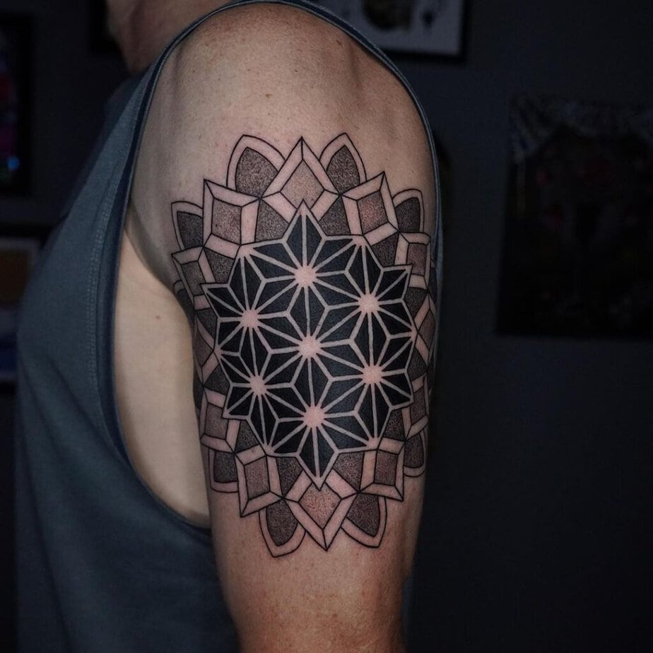 18. A dotwork tattoo on the upper arm
