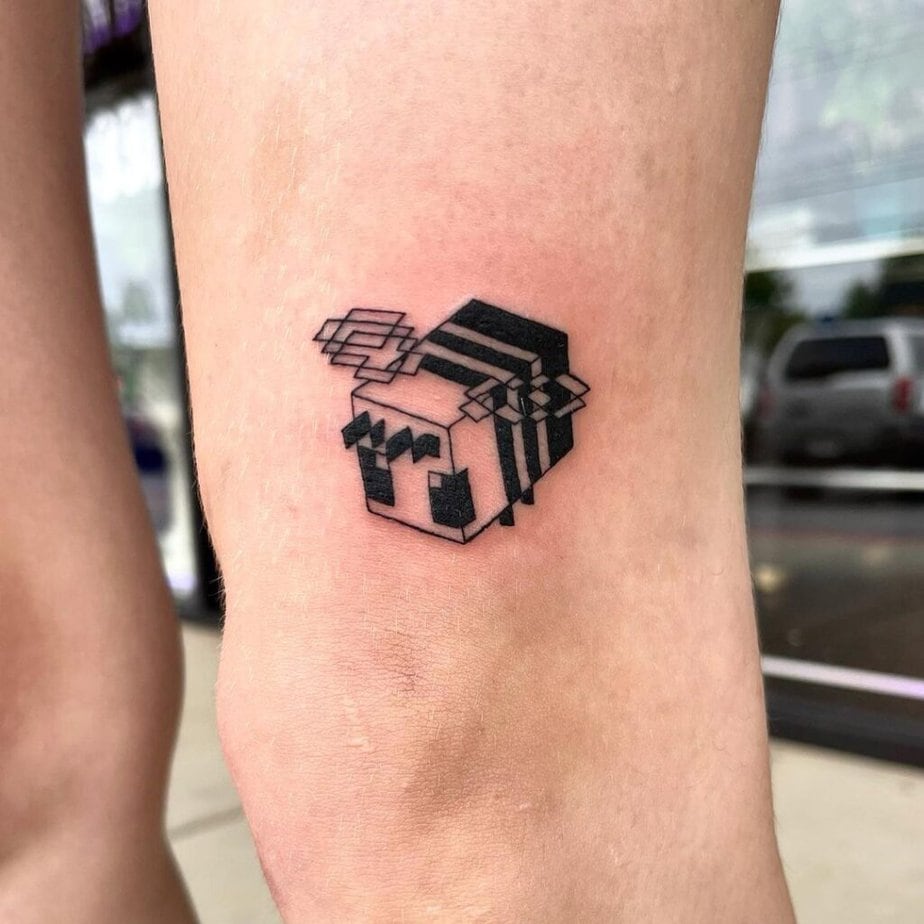 Black ink Minecraft bee tattoo