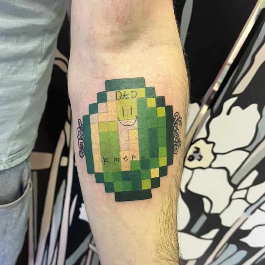 Minecraft emerald tattoo on forearm