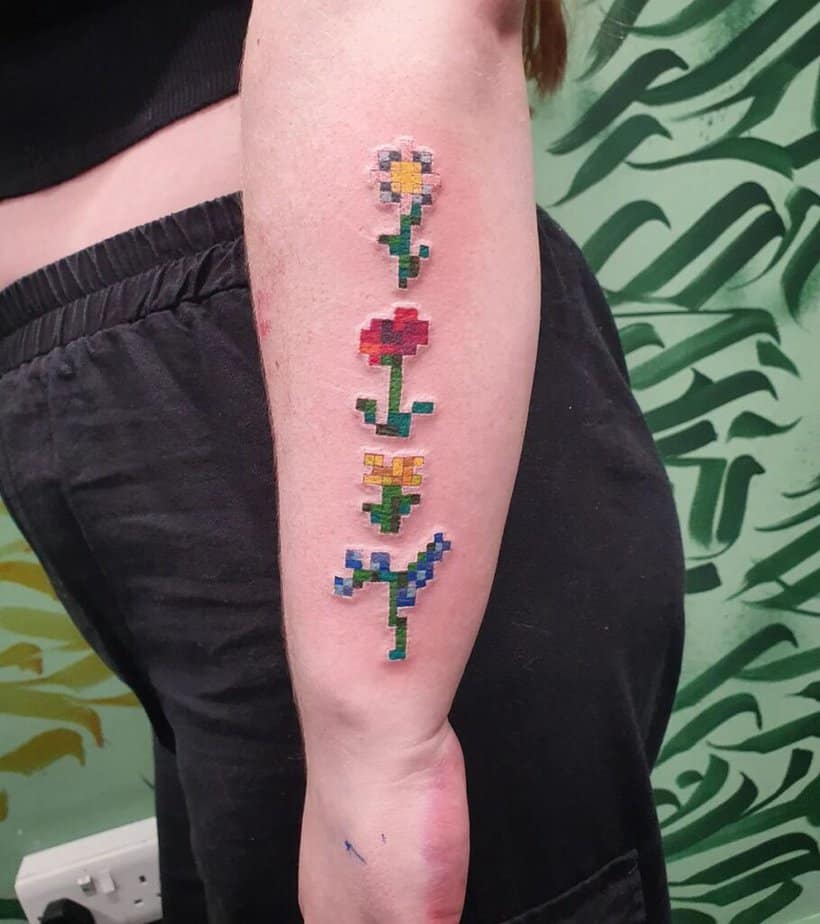 Minecraft flowers tattoo on side of arm