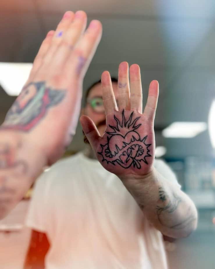 Hand-poked heart palm tattoo