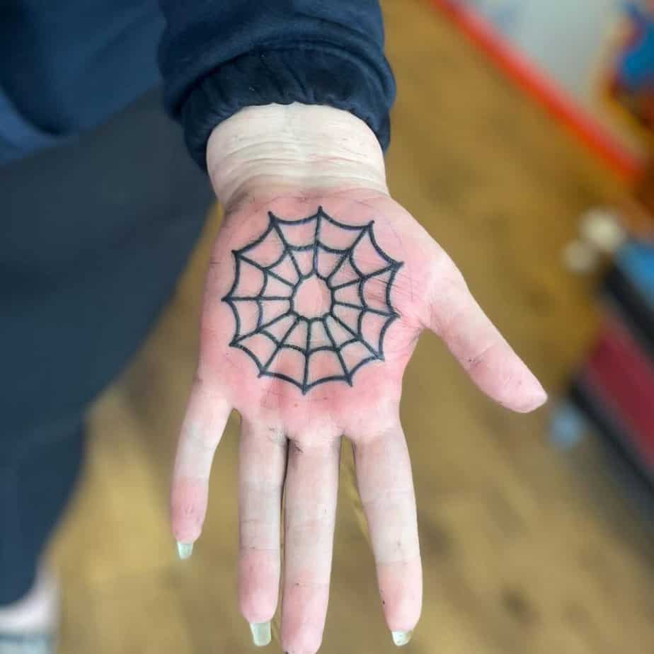 Spiderweb palm tattoo