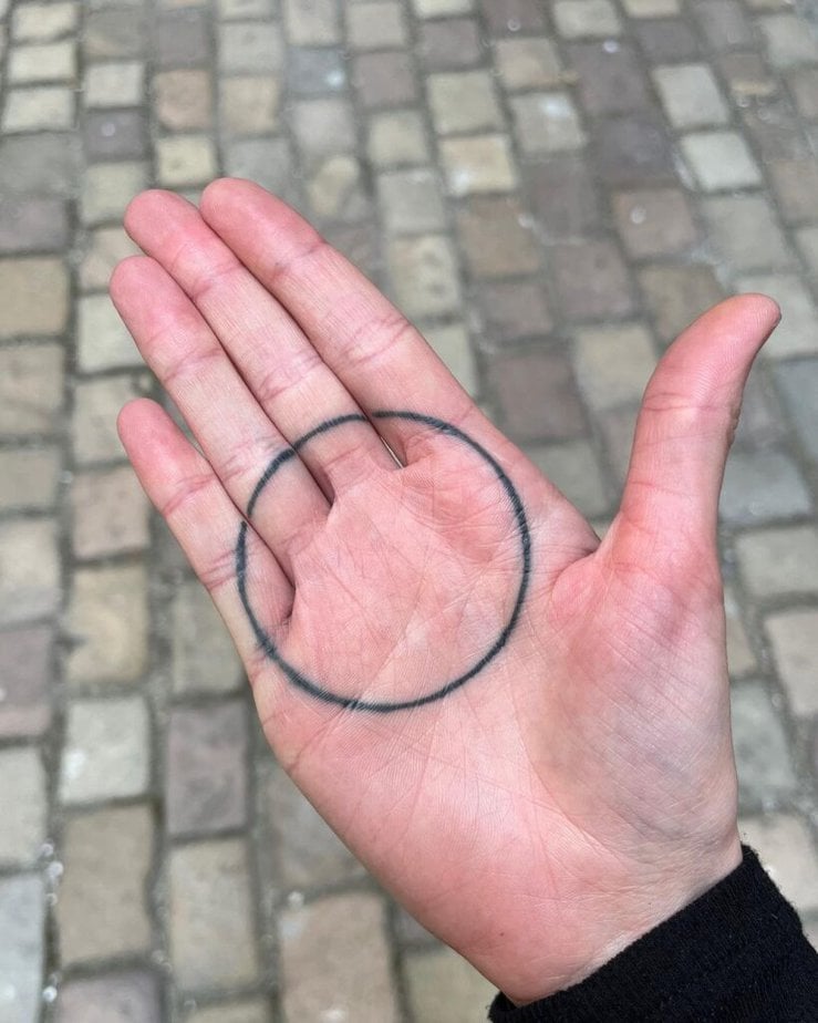 Circle palm tattoo