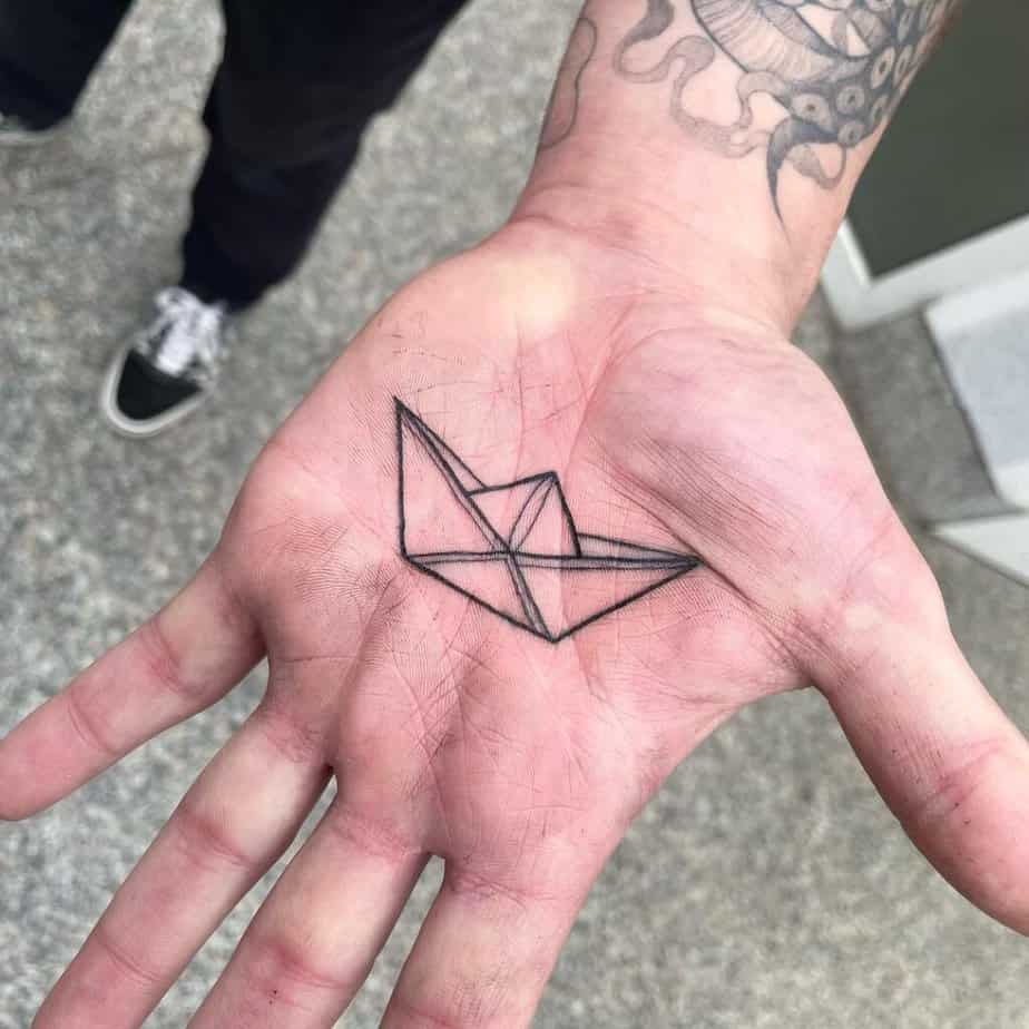 Paper boat palm tattoo