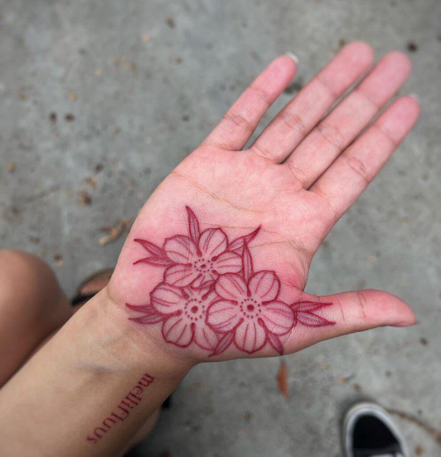 Red ink palm tattoo