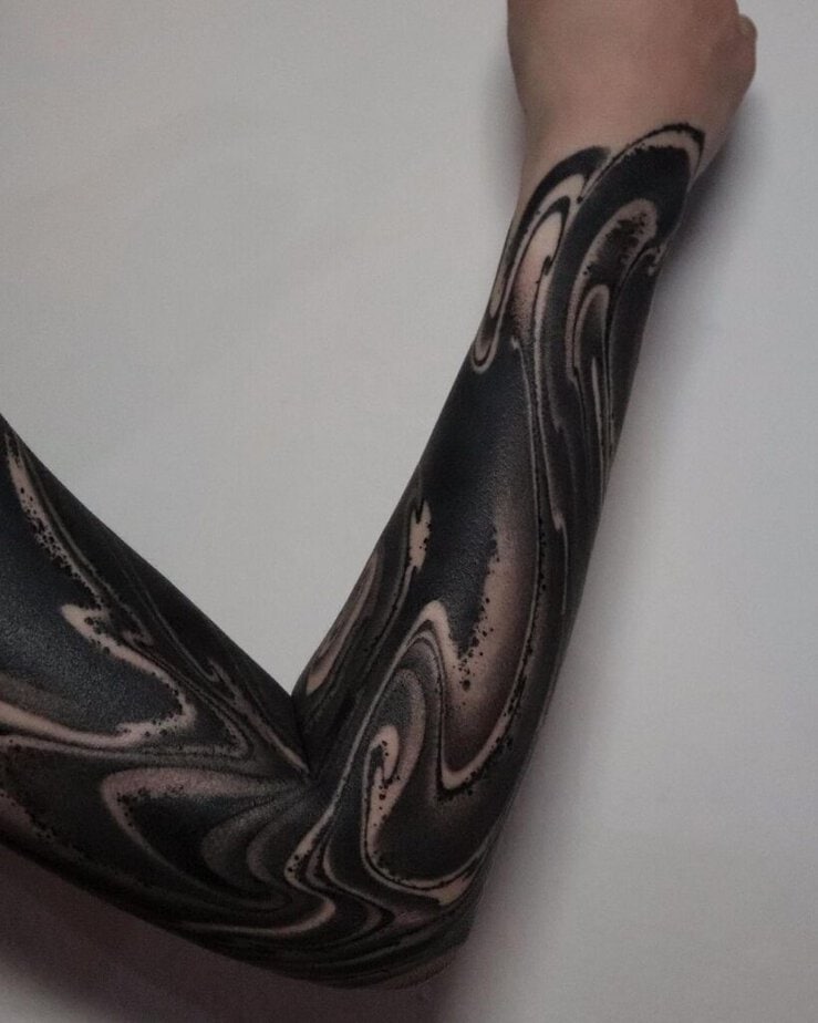 12. A black tattoo sleeve with swirls