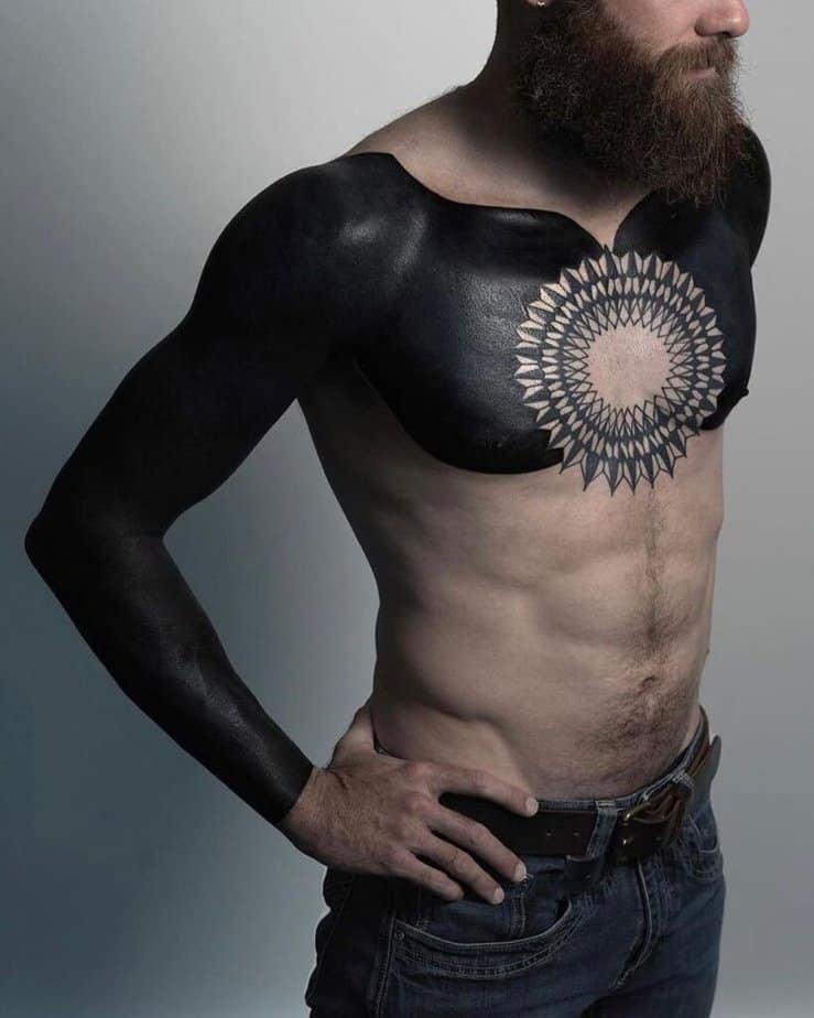 18. A full black sleeve tattoo with a chest piece