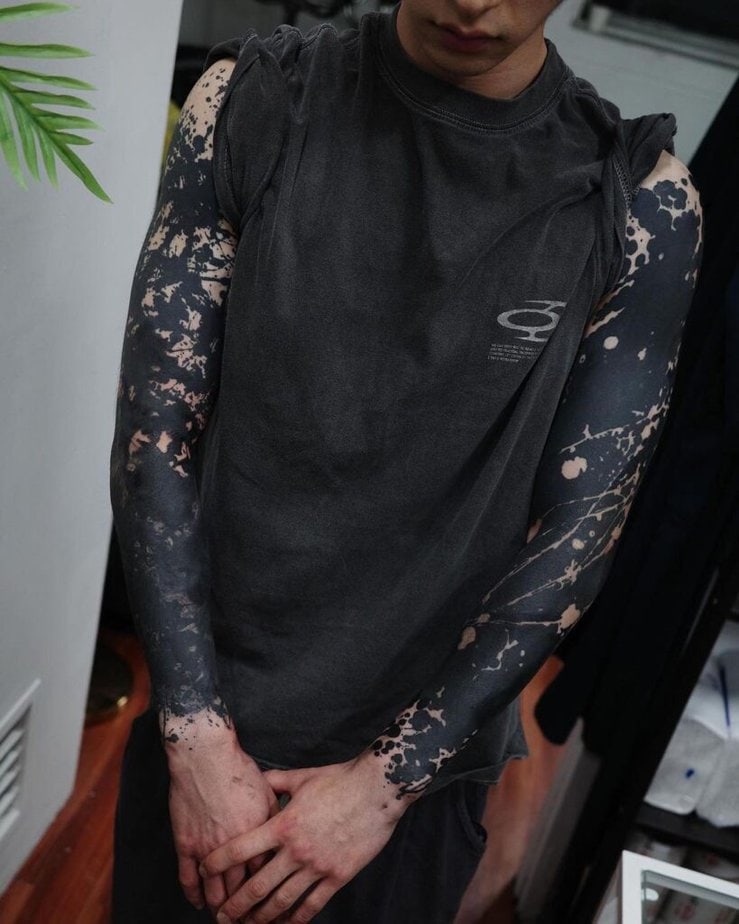 19. A splatter-style black sleeve tattoo