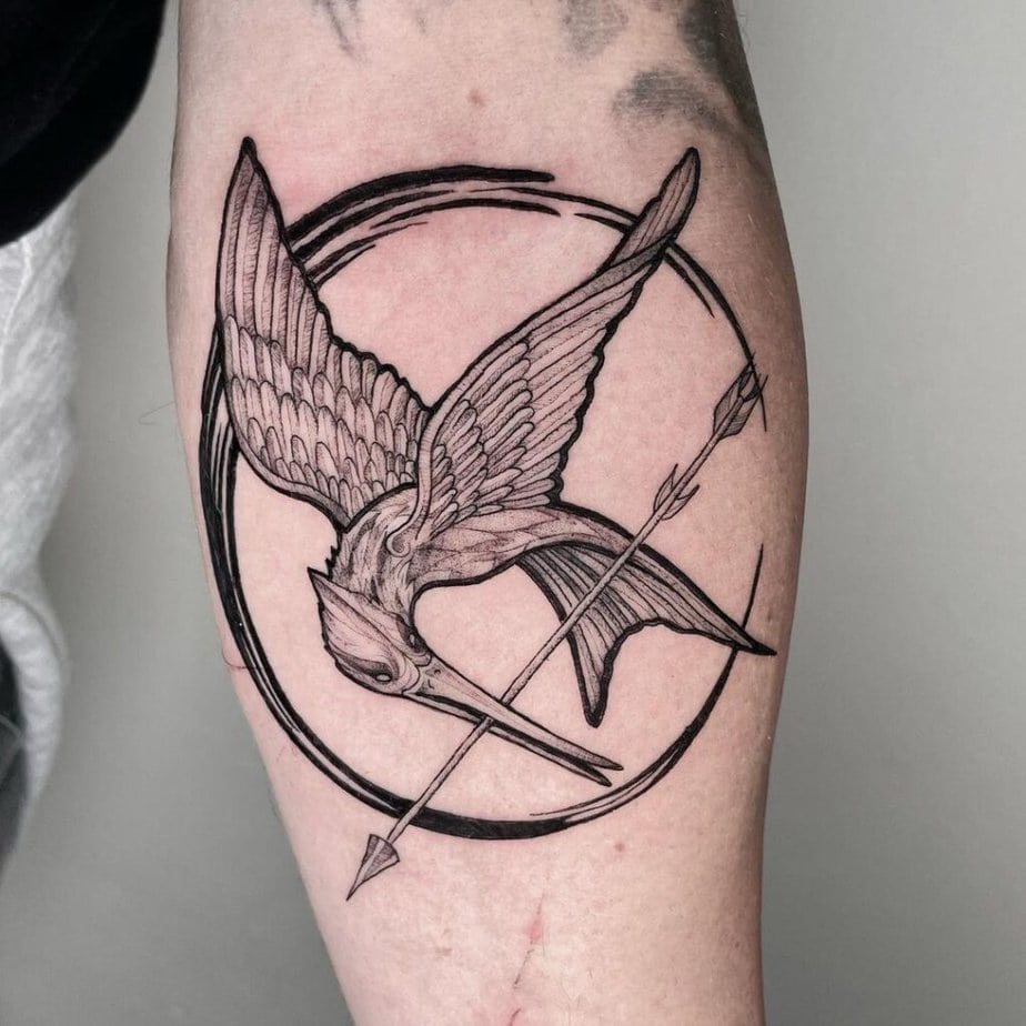 1. A blackwork Mockingjay tattoo