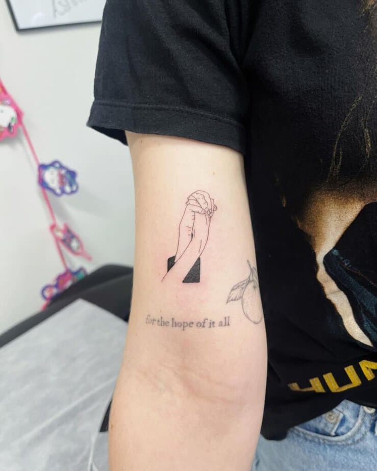 17. A tattoo of Peeta and Katniss holding hands 