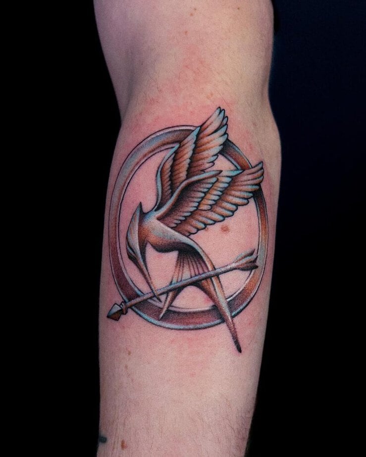 4. A chrome Mockingjay symbol tattoo 