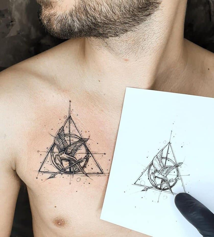 7. A tattoo of the Mockingjay symbol on the chest