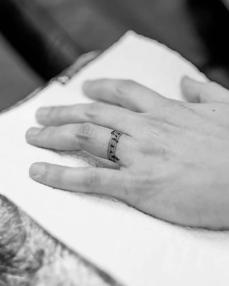 6. Melodic wedding ring tattoos