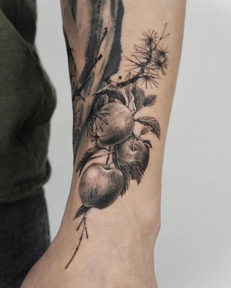 14. A black apple tree tattoo