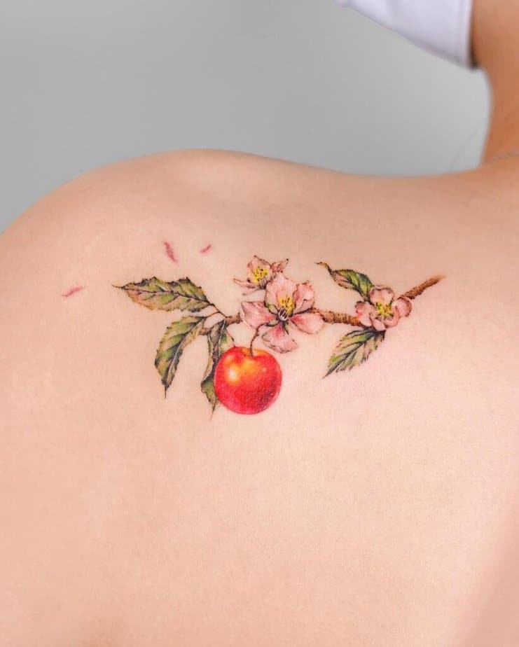17. An apple branch tattoo on the shoulder